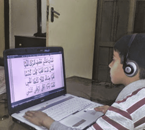 Young boy reading quran online